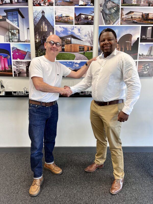 Ayanda Mahachi and Graham McDabry shaking hands.